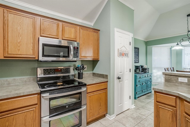 kitchen with pendant lighting, crown molding, vaulted ceiling, light tile patterned floors, and stainless steel appliances