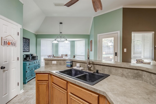 kitchen featuring ceiling fan, crown molding, sink, lofted ceiling, and light tile patterned flooring