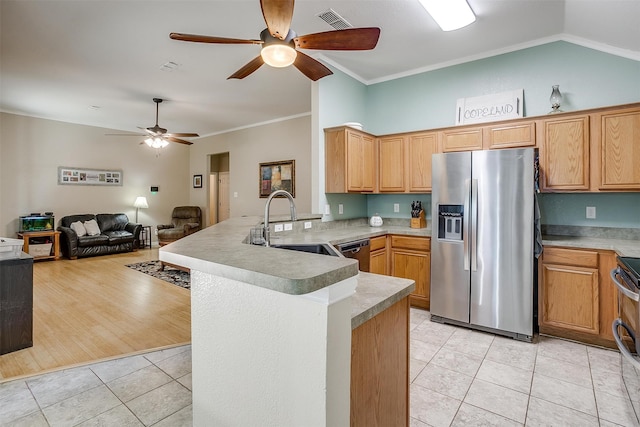 kitchen with sink, stainless steel appliances, kitchen peninsula, light hardwood / wood-style floors, and ornamental molding