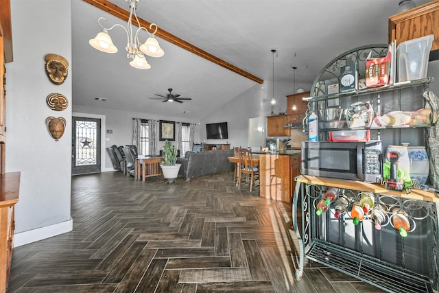 dining area featuring vaulted ceiling with beams, dark parquet floors, and ceiling fan with notable chandelier