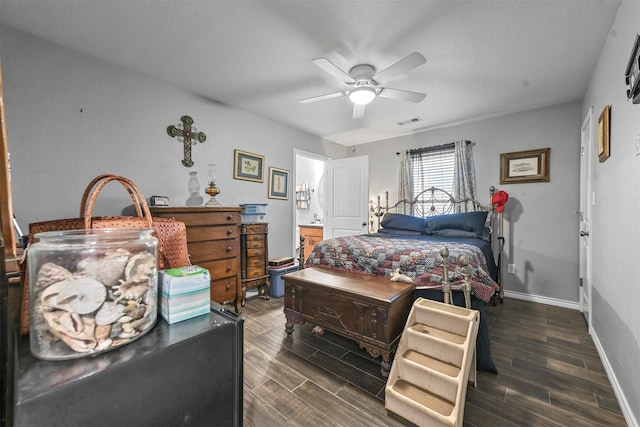 bedroom with dark hardwood / wood-style floors and ceiling fan