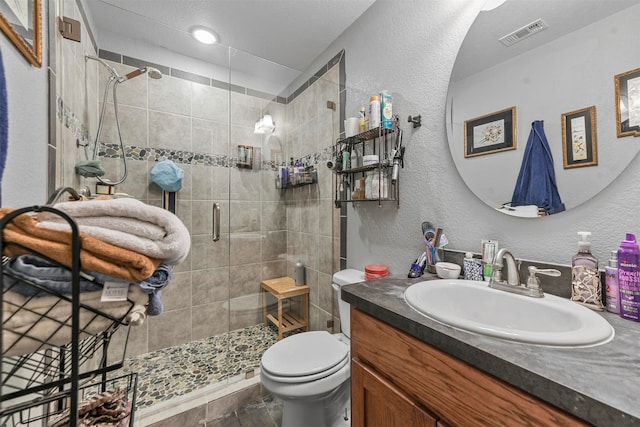 bathroom with vanity, an enclosed shower, and toilet