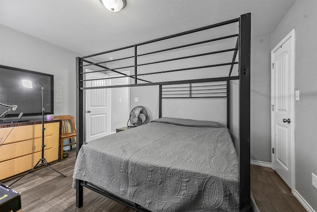 bedroom featuring wood-type flooring and a textured ceiling