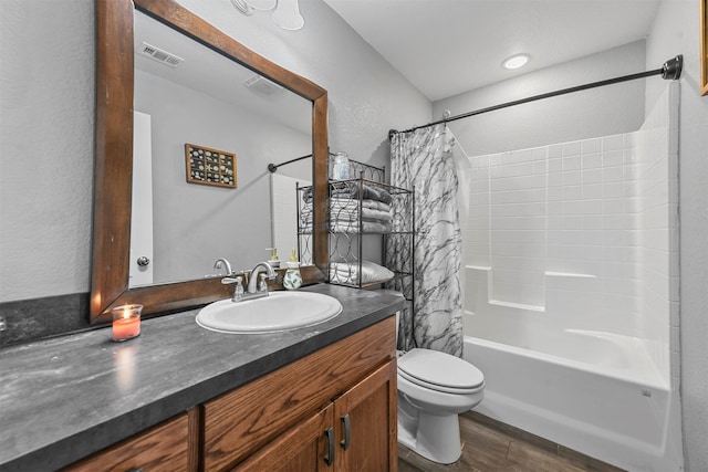 full bathroom featuring hardwood / wood-style floors, vanity, toilet, and shower / bath combination with curtain