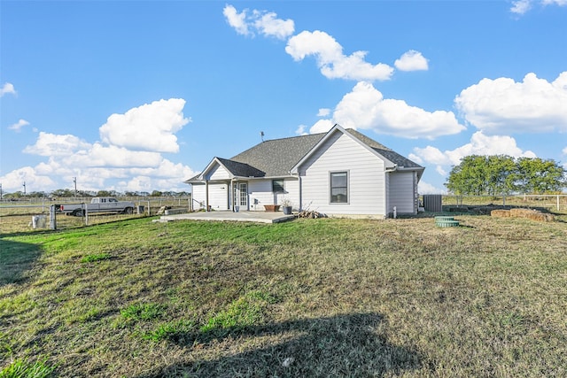 back of house with a yard and a patio