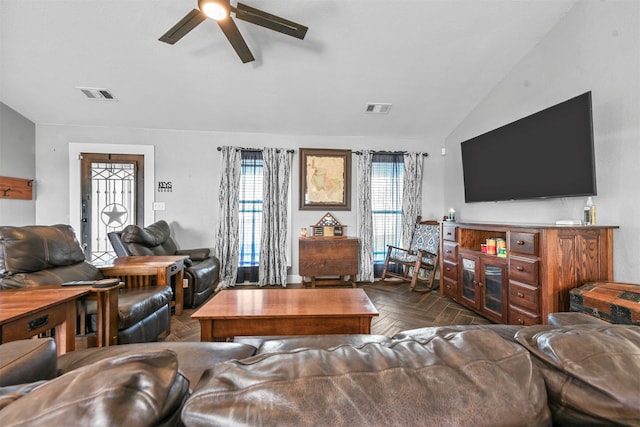 living room featuring dark parquet floors, ceiling fan, and lofted ceiling