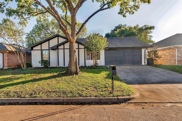 view of front of property with a garage and a front lawn