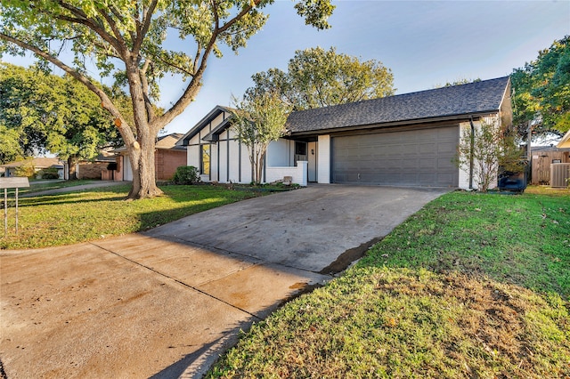 view of front of house featuring a front lawn and a garage