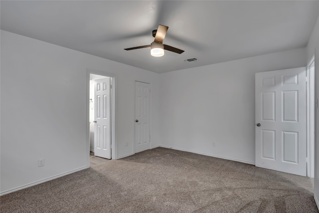 spare room with light colored carpet and ceiling fan