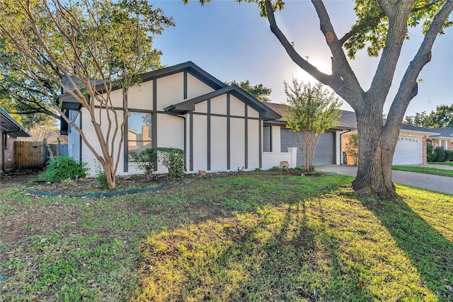 view of front of house featuring a garage and a front lawn