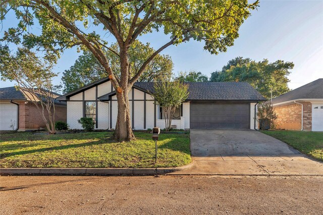 view of front of home featuring a garage and a front yard