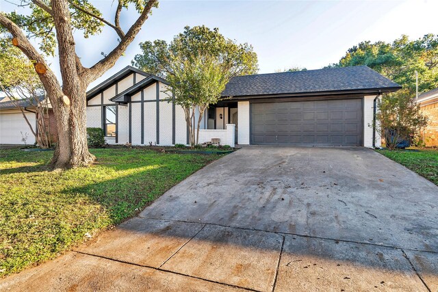 view of front of house with a front yard and a garage