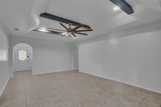 tiled spare room with beamed ceiling and ceiling fan