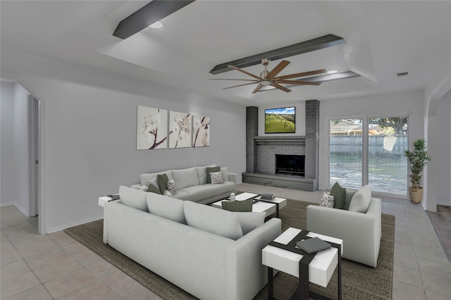 living room with ceiling fan, light tile patterned flooring, and a fireplace