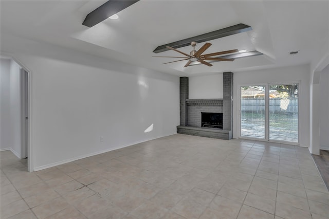 unfurnished living room featuring ceiling fan, light tile patterned floors, and a brick fireplace