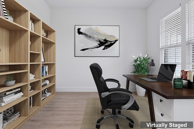 office with light hardwood / wood-style flooring