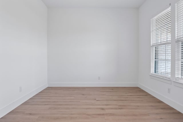 spare room with light hardwood / wood-style flooring