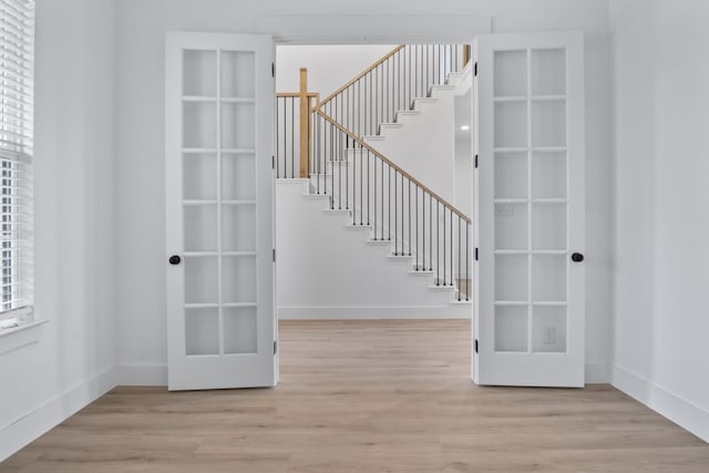 interior space with french doors and wood-type flooring