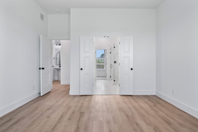 unfurnished room with light wood-type flooring