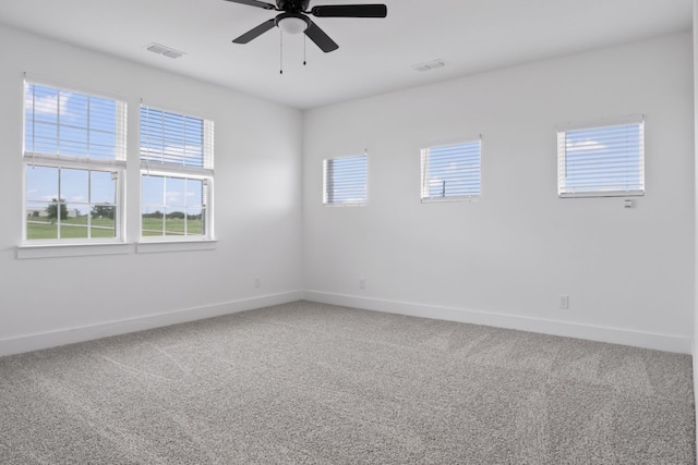 unfurnished room with ceiling fan and carpet