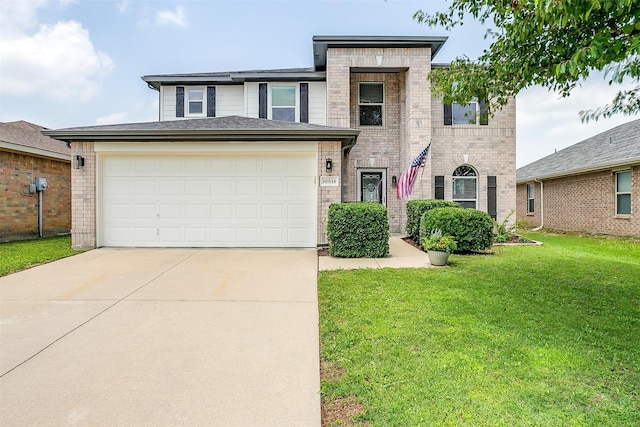 view of front of property with a garage and a front lawn