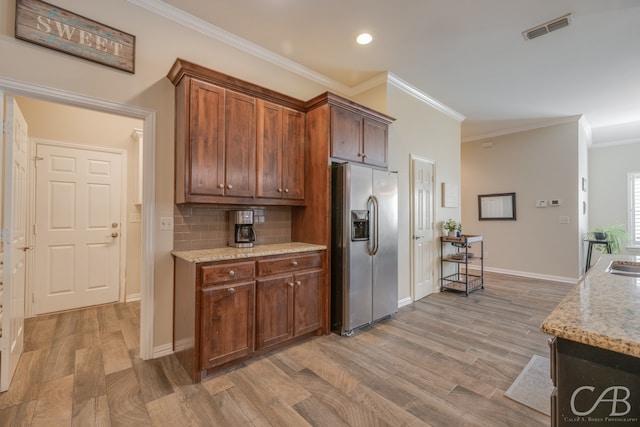 kitchen featuring tasteful backsplash, hardwood / wood-style floors, stainless steel refrigerator with ice dispenser, and ornamental molding