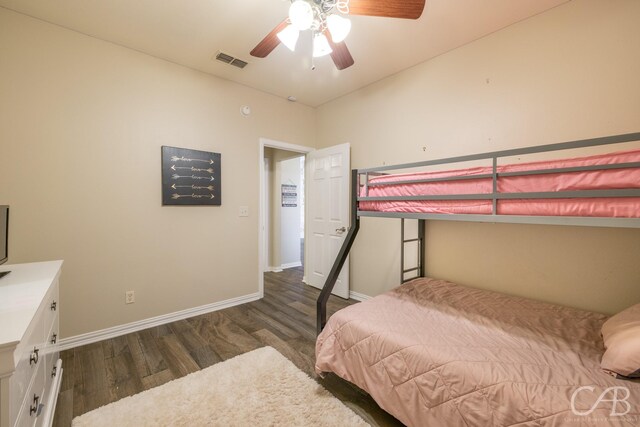 bedroom with ceiling fan and dark hardwood / wood-style flooring