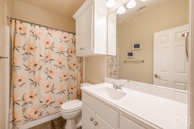 bathroom featuring hardwood / wood-style floors, vanity, toilet, and walk in shower