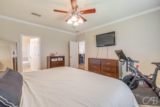 bedroom with ceiling fan, ensuite bathroom, carpet floors, and crown molding