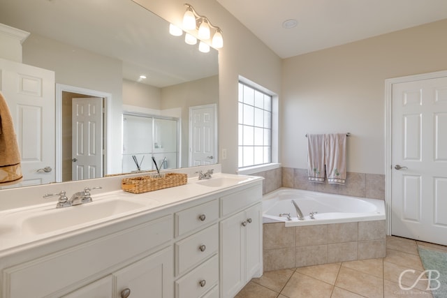 bathroom featuring plus walk in shower, vanity, and tile patterned floors