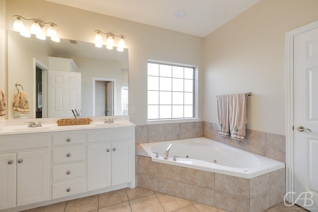 bathroom with vanity, tile patterned floors, and tiled tub