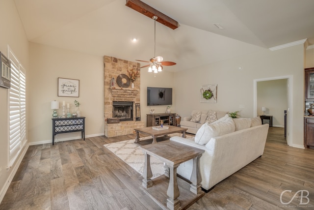 living room with beam ceiling, ceiling fan, a fireplace, and hardwood / wood-style flooring