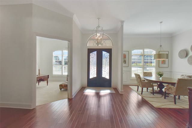 entryway with crown molding, french doors, and wood-type flooring