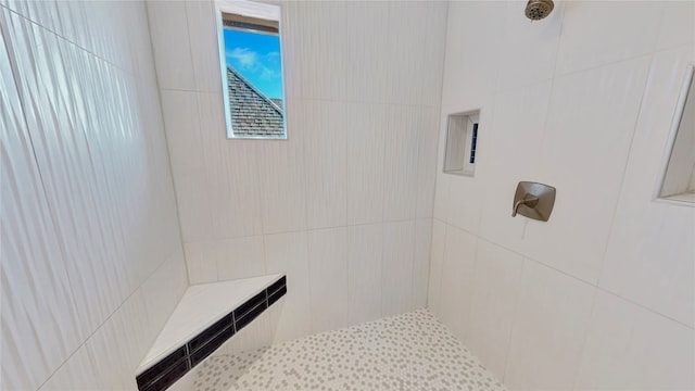 bathroom with tiled shower