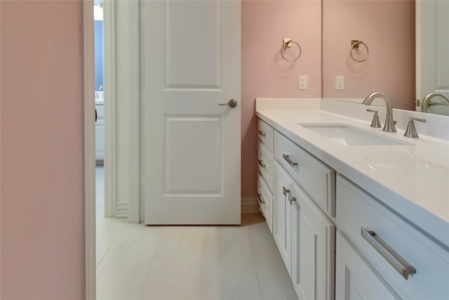 bathroom featuring tile patterned flooring and vanity