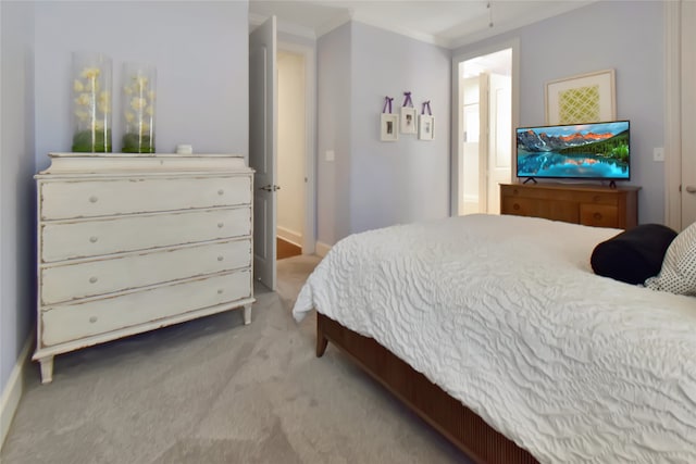 bedroom featuring crown molding and light carpet