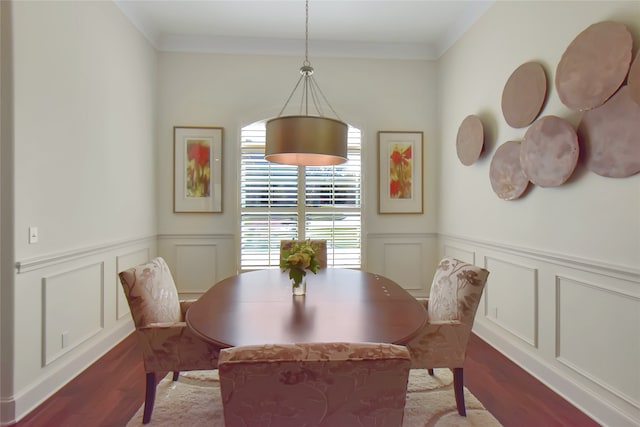 dining room with hardwood / wood-style flooring and ornamental molding