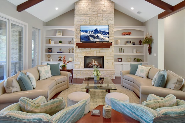 living room featuring lofted ceiling with beams, built in features, light wood-type flooring, and a fireplace