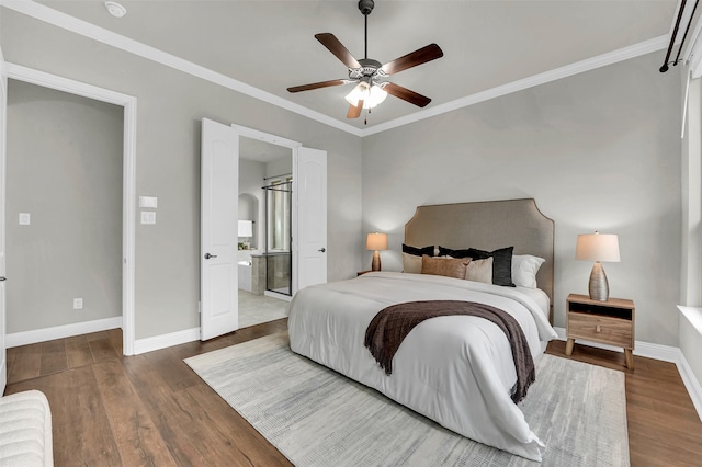 bedroom featuring ensuite bath, ceiling fan, dark wood-type flooring, and ornamental molding