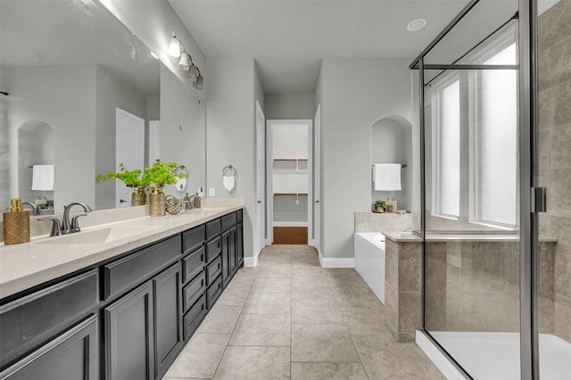 bathroom featuring tile patterned flooring, vanity, and independent shower and bath