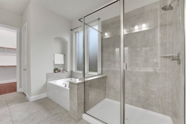 bathroom featuring tile patterned flooring, plenty of natural light, and shower with separate bathtub