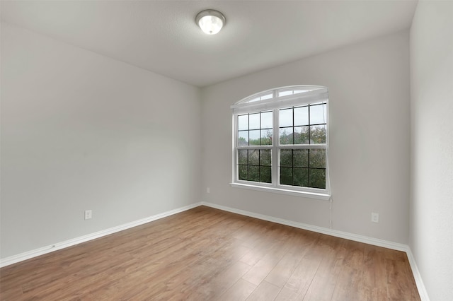 unfurnished room with wood-type flooring