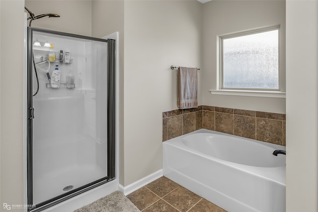 bathroom featuring tile patterned flooring and independent shower and bath