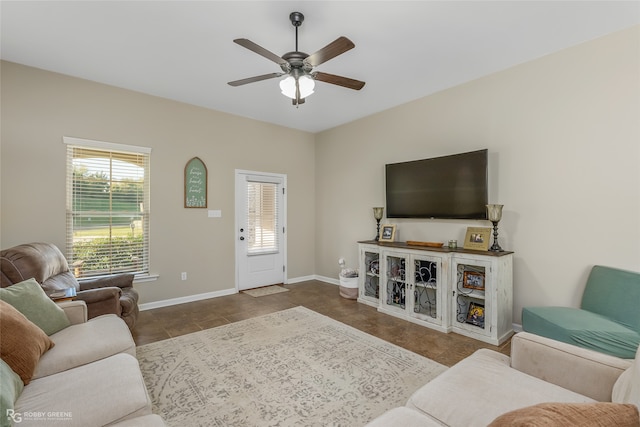 tiled living room with ceiling fan