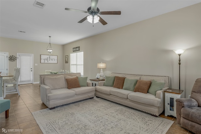 tiled living room featuring ceiling fan