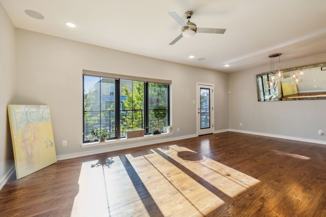 unfurnished room with ceiling fan and dark hardwood / wood-style floors