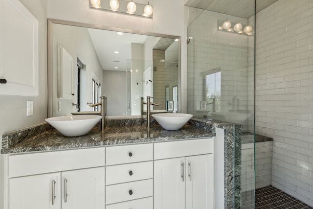 bathroom featuring vanity and an enclosed shower