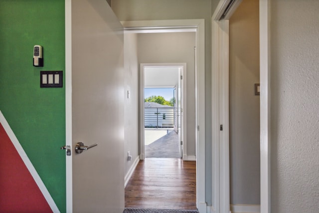 corridor with hardwood / wood-style flooring