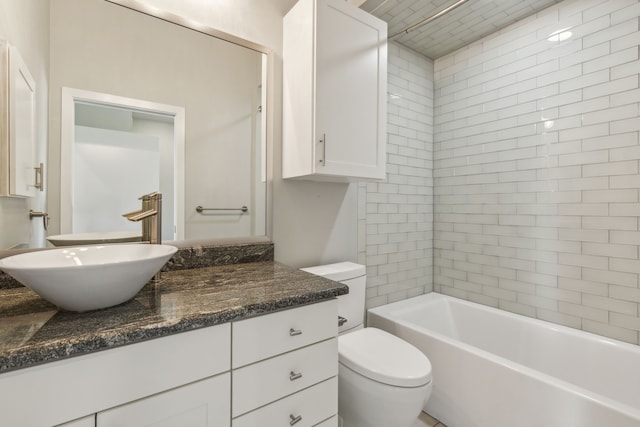 full bathroom featuring vanity, toilet, and tiled shower / bath