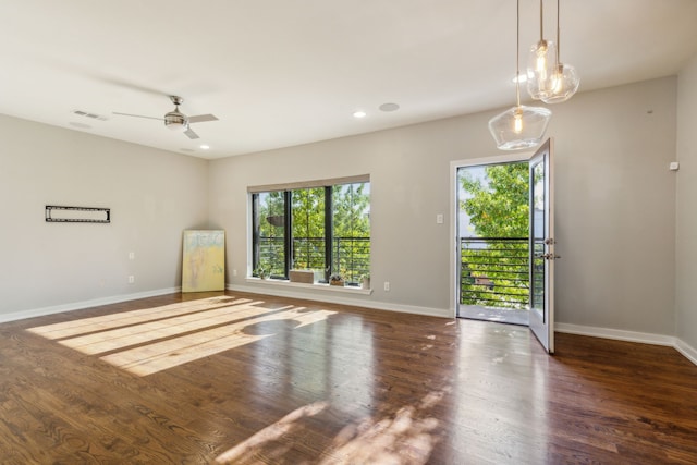 unfurnished room featuring ceiling fan and dark hardwood / wood-style flooring